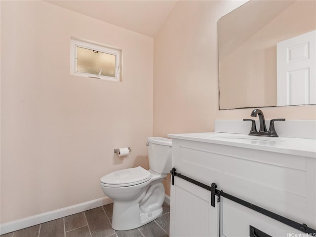 92-308 Palaulau Pl Unit 70, Kapolei, HI 96707 - half bathroom featuring baseboards, toilet, vanity, and wood finished floors