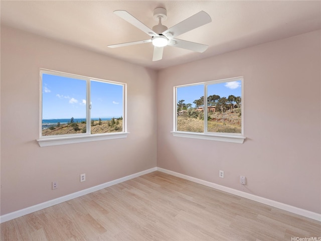 92-308 Palaulau Pl Unit 70, Kapolei, HI 96707 - spare room with light wood-style flooring, ceiling fan, and baseboards