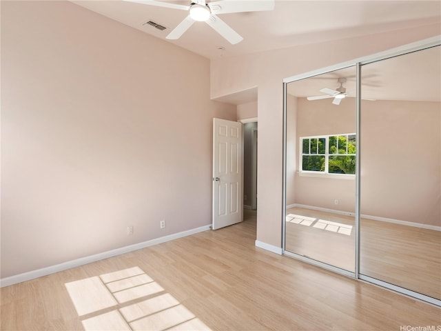 92-308 Palaulau Pl Unit 70, Kapolei, HI 96707 - unfurnished bedroom with a closet, light wood-style flooring, baseboards, and lofted ceiling