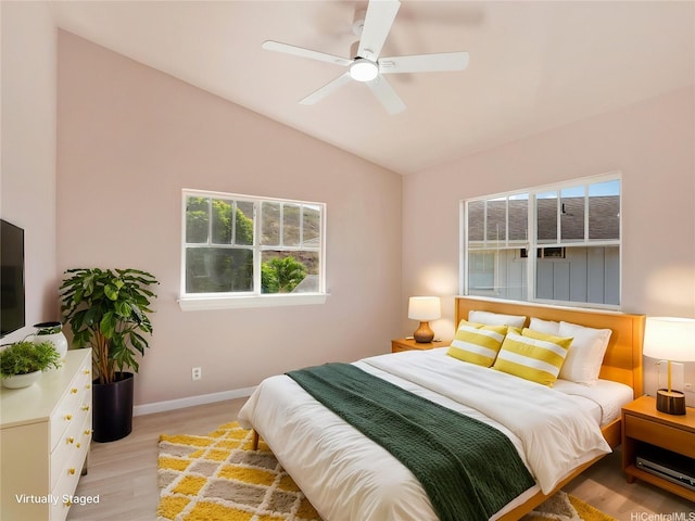 92-308 Palaulau Pl Unit 70, Kapolei, HI 96707 - bedroom with multiple windows, vaulted ceiling, light wood-style flooring, and baseboards