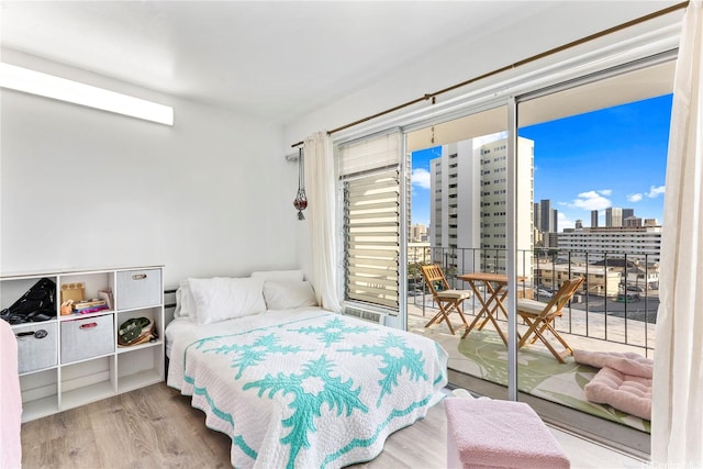 1616 Kewalo St Unit 503, Honolulu, HI 96822 - bedroom featuring multiple windows, access to exterior, wood finished floors, and a view of skyline