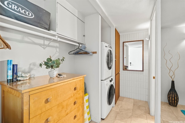 53-567 Kamehameha Hwy Unit 503, Hauula, HI 96717 - laundry room with stacked washer and clothes dryer, cabinet space, and light tile patterned floors