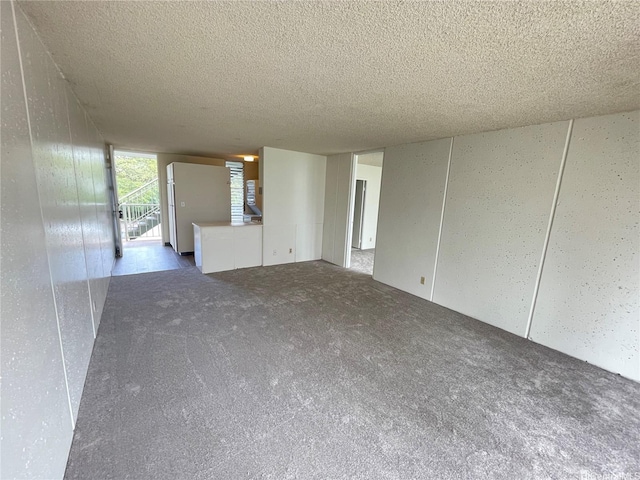 95-009 Waikalani Dr Unit B202, Mililani, HI 96789 - unfurnished living room featuring carpet flooring and a textured ceiling
