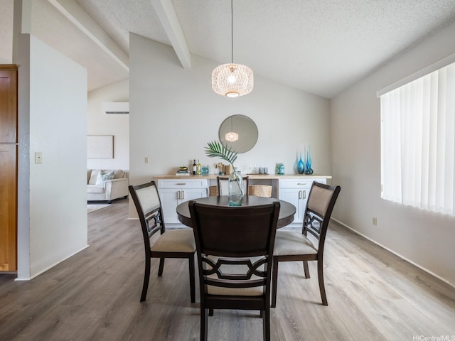 45-812 Kupohu St, Kaneohe, HI 96744 - dining room featuring light wood-style flooring, an AC wall unit, and a textured ceiling