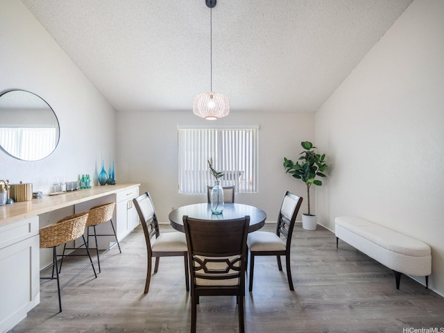 45-812 Kupohu St, Kaneohe, HI 96744 - dining space featuring a textured ceiling, light wood-type flooring, lofted ceiling, and baseboards