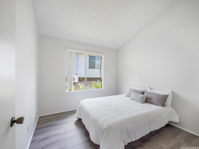 45-812 Kupohu St, Kaneohe, HI 96744 - bedroom with wood finished floors and a textured ceiling