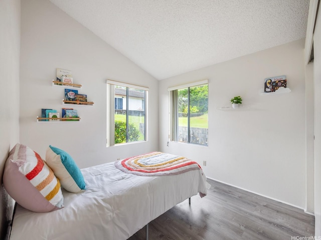 45-812 Kupohu St, Kaneohe, HI 96744 - bedroom with wood finished floors, lofted ceiling, and a textured ceiling