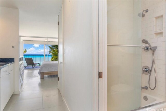 2877 Kalakaua Ave Unit 306, Honolulu, HI 96815 - bathroom featuring tile patterned flooring, vanity, bathtub / shower combination, ensuite bath, and baseboards