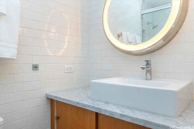 2877 Kalakaua Ave Unit 306, Honolulu, HI 96815 - bathroom featuring tile walls, a shower with shower door, and vanity