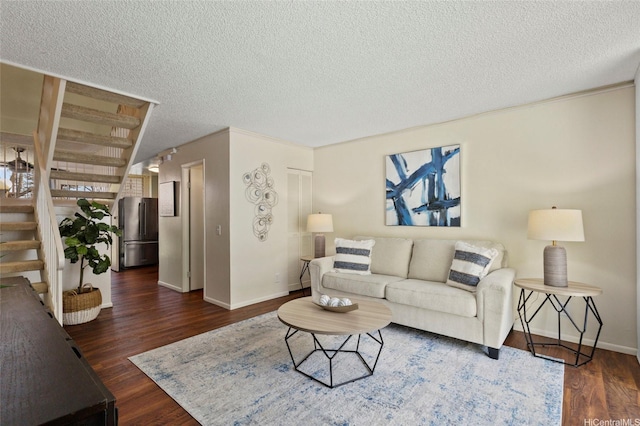95-314 Kaloapau St Unit 122, Mililani, HI 96789 - living area featuring a textured ceiling, stairway, baseboards, and wood finished floors
