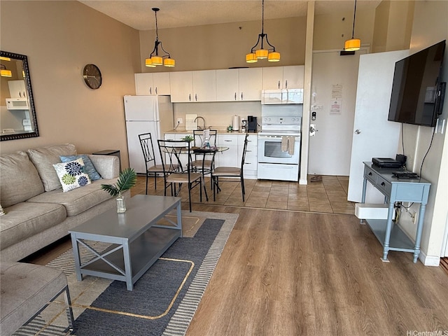 201 Ohua Ave Unit 3709-I, Honolulu, HI 96815 - living area featuring dark wood-style flooring and a towering ceiling
