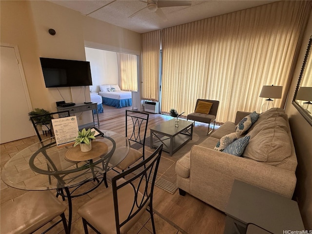 201 Ohua Ave Unit 3709-I, Honolulu, HI 96815 - living room featuring wood finished floors, ceiling fan, and a wall unit AC
