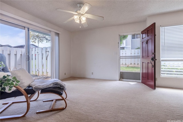 94-1064 Paawalu St Unit N1, Waipahu, HI 96797 - sitting room featuring light carpet, a textured ceiling, and a ceiling fan
