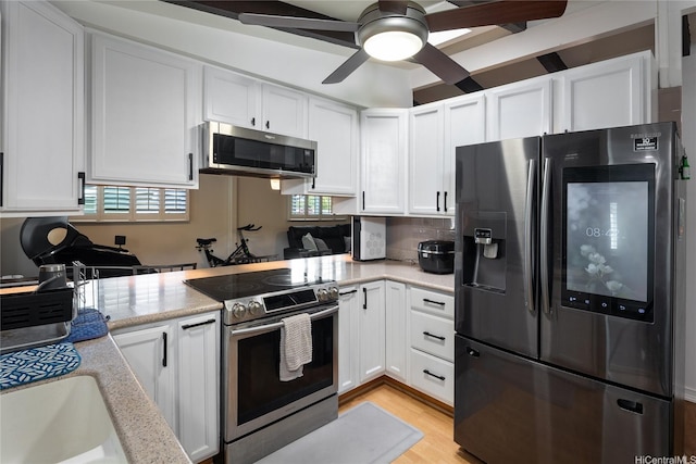 2283 Anapanapa St, Pearl City, HI 96782 - kitchen featuring stainless steel appliances, white cabinets, a ceiling fan, light wood-style floors, and light stone countertops