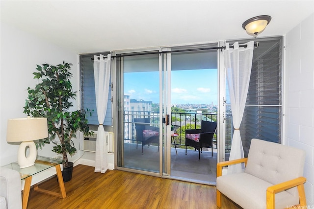 1541 Dominis St Unit 1601, Honolulu, HI 96822 - sitting room with wood finished floors, cooling unit, baseboards, and expansive windows