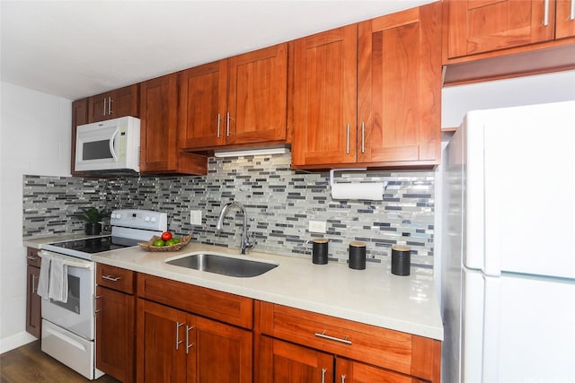 1541 Dominis St Unit 1601, Honolulu, HI 96822 - kitchen featuring white appliances, a sink, light countertops, decorative backsplash, and brown cabinetry