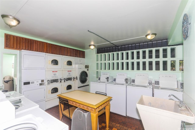 1541 Dominis St Unit 1601, Honolulu, HI 96822 - communal laundry room with stacked washer and clothes dryer, washing machine and clothes dryer, and brick patterned flooring