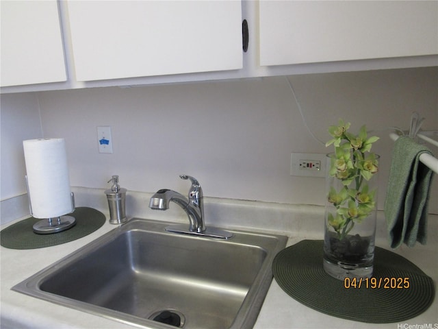1670 Kalakaua Ave Unit 603, Honolulu, HI 96826 - kitchen view of a sink and white cabinets