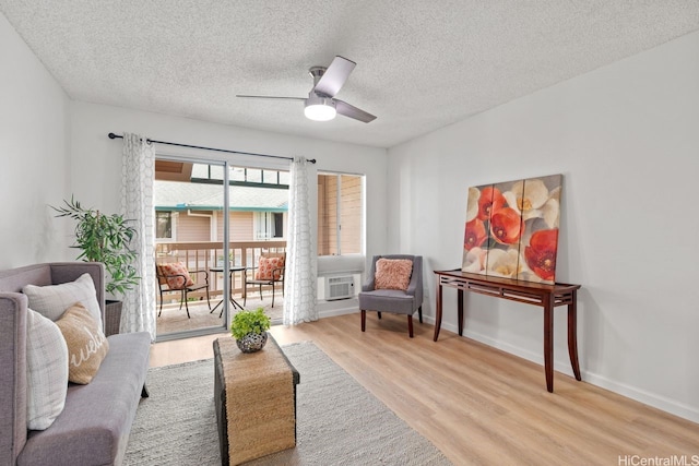 94-870 Lumiauau St Unit T203, Waipahu, HI 96797 - living area featuring wood finished floors, a ceiling fan, a textured ceiling, and baseboards