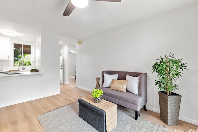 94-870 Lumiauau St Unit T203, Waipahu, HI 96797 - sitting room featuring a ceiling fan, light wood finished floors, and baseboards