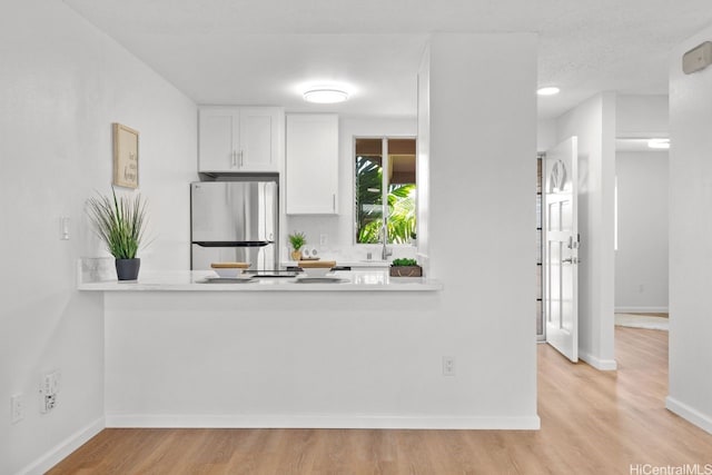 94-870 Lumiauau St Unit T203, Waipahu, HI 96797 - kitchen featuring freestanding refrigerator, wood finished floors, light countertops, a sink, and baseboards