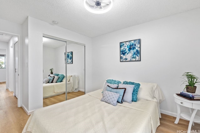 94-870 Lumiauau St Unit T203, Waipahu, HI 96797 - bedroom featuring wood finished floors, a closet, a textured ceiling, and baseboards