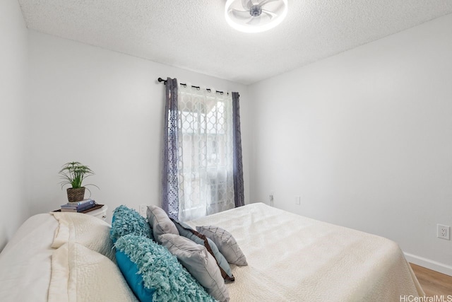 94-870 Lumiauau St Unit T203, Waipahu, HI 96797 - bedroom with wood finished floors, a textured ceiling, and baseboards
