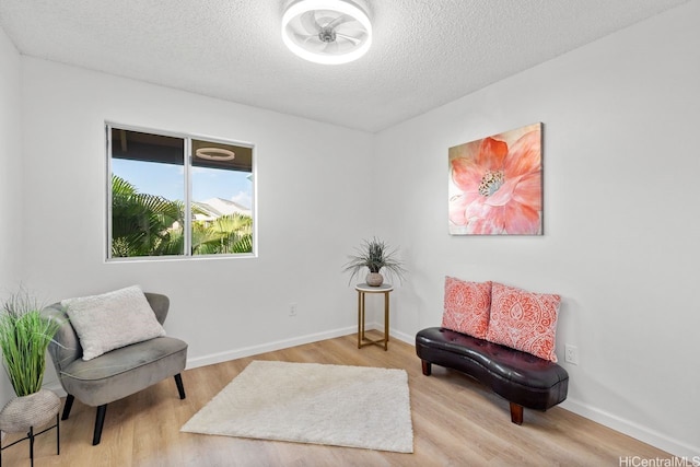 94-870 Lumiauau St Unit T203, Waipahu, HI 96797 - living area with a textured ceiling, wood finished floors, and baseboards