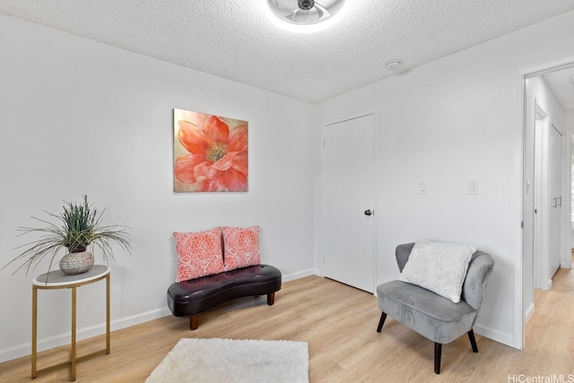 94-870 Lumiauau St Unit T203, Waipahu, HI 96797 - sitting room with light wood finished floors, a textured ceiling, and baseboards