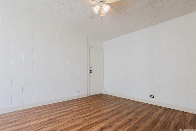 2509 Ala Wai Blvd Unit 804, Honolulu, HI 96815 - empty room featuring wood finished floors, ceiling fan, a textured ceiling, and concrete block wall