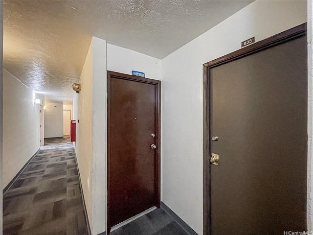 2509 Ala Wai Blvd Unit 804, Honolulu, HI 96815 - hallway featuring a textured ceiling and baseboards