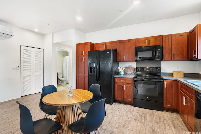 458 Manawai St Unit 512, Kapolei, HI 96707 - kitchen with black appliances, light wood-style flooring, a wall unit AC, and recessed lighting