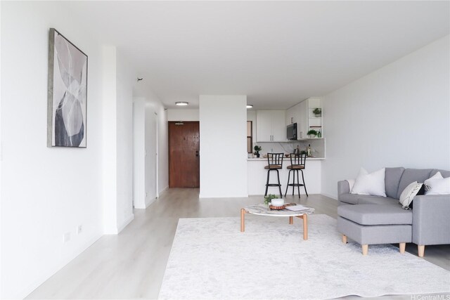 98-501 Koauka Loop Unit A1006, Aiea, HI 96701 - living room featuring light wood-type flooring