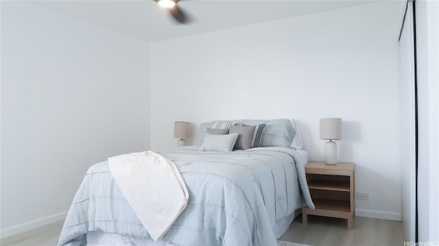 98-501 Koauka Loop Unit A1006, Aiea, HI 96701 - bedroom with baseboards, wood finished floors, and ceiling fan