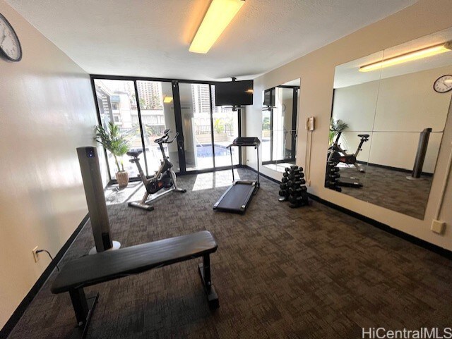 1850 Ala Moana Blvd Unit 1007, Honolulu, HI 96815 - gym featuring carpet, baseboards, and a wall of windows