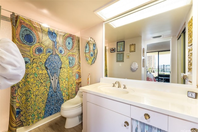 1860 Ala Moana Blvd Unit 1206, Honolulu, HI 96815 - bathroom featuring vanity, toilet, wood finished floors, and curtained shower
