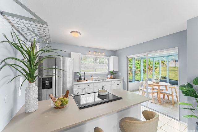 47-612 Hui Kelu St, Kaneohe, HI 96744 - kitchen featuring stainless steel fridge with ice dispenser, black electric cooktop, light countertops, white cabinetry, and light tile patterned flooring