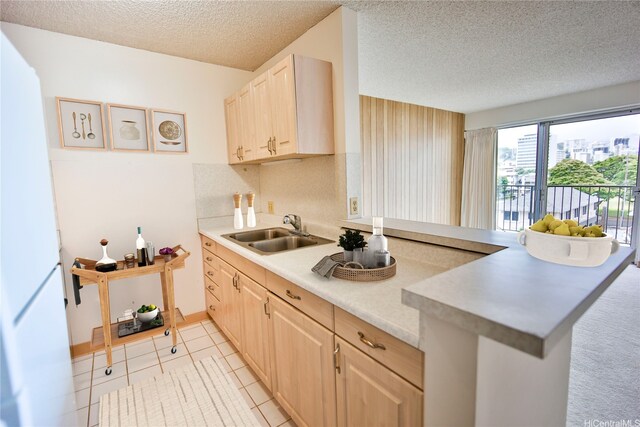 725 Piikoi St Unit 405, Honolulu, HI 96814 - kitchen featuring a sink, light brown cabinetry, light countertops, a textured ceiling, and freestanding refrigerator