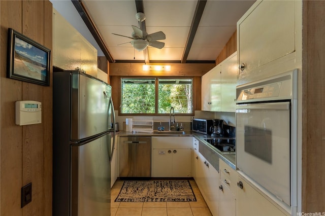 41-1025 Nenue St, Waimanalo, HI 96795 - kitchen with stainless steel appliances, a ceiling fan, light tile patterned flooring, stainless steel counters, and white cabinets