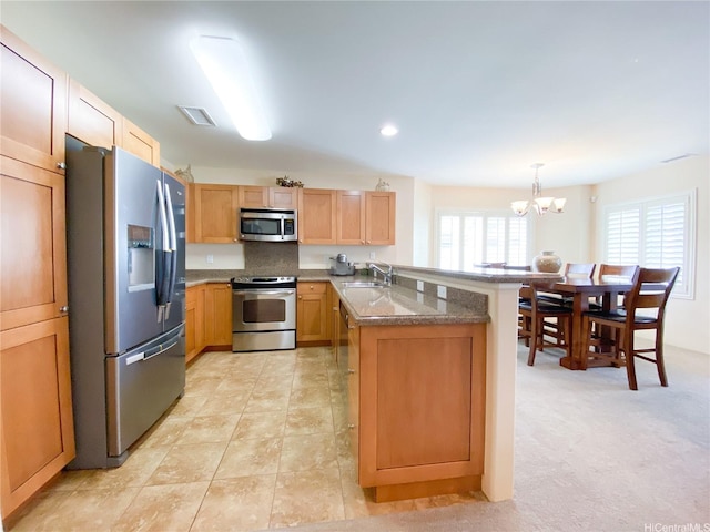 91-1775 Waiaama St, Ewa Beach, HI 96706 - kitchen with stainless steel appliances, a peninsula, a sink, a chandelier, and hanging light fixtures