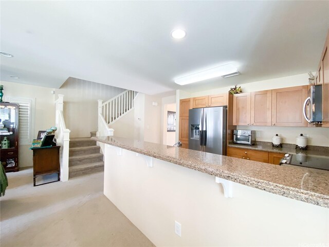 91-1775 Waiaama St, Ewa Beach, HI 96706 - kitchen with appliances with stainless steel finishes, a breakfast bar, light stone counters, and recessed lighting
