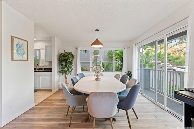 2290 Akepa St, Pearl City, HI 96782 - dining area featuring a textured ceiling and light wood finished floors