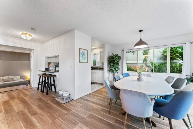 2290 Akepa St, Pearl City, HI 96782 - dining space featuring a textured ceiling, light wood-style floors, and baseboards
