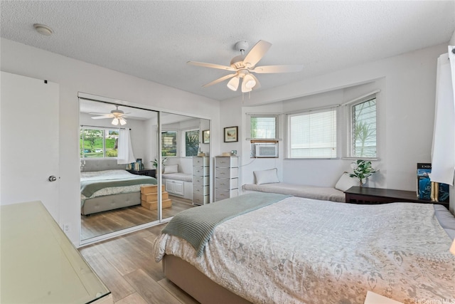 2290 Akepa St, Pearl City, HI 96782 - bedroom featuring wood finished floors, a closet, a textured ceiling, a ceiling fan, and cooling unit