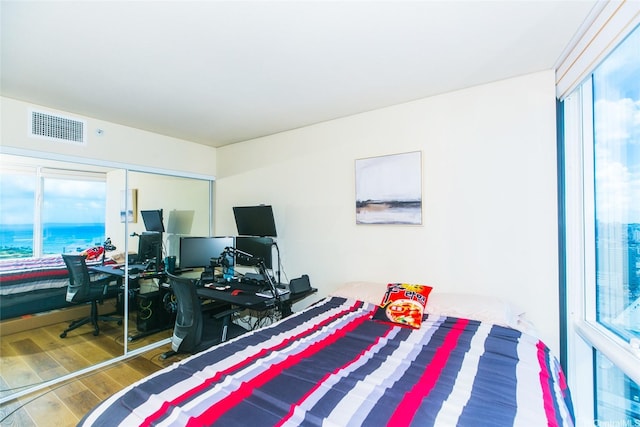 1296 Kapiolani Blvd Unit 3805, Honolulu, HI 96814 - bedroom featuring multiple windows, wood finished floors, and a desk