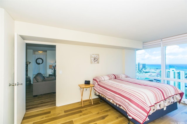 1296 Kapiolani Blvd Unit 3805, Honolulu, HI 96814 - bedroom featuring light wood-type flooring, floor to ceiling windows, and a city view