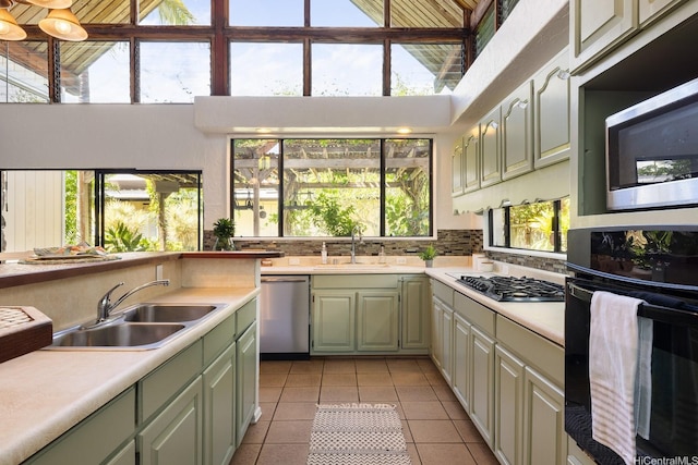 337 Wanaao Rd, Kailua, HI 96734 - kitchen with appliances with stainless steel finishes, green cabinetry, a sink, light countertops, and a towering ceiling