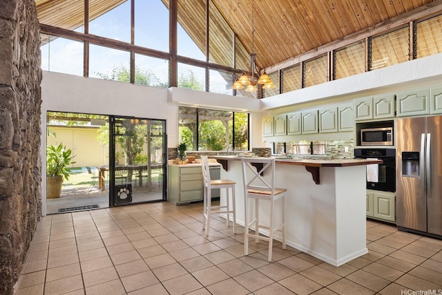 337 Wanaao Rd, Kailua, HI 96734 - kitchen featuring stainless steel appliances, light tile patterned floors, high vaulted ceiling, a breakfast bar area, and light countertops