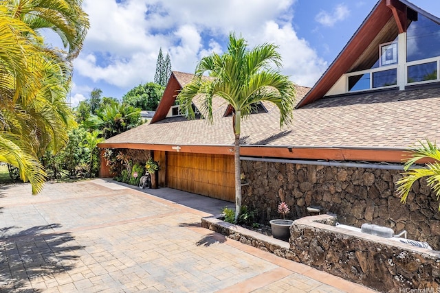 337 Wanaao Rd, Kailua, HI 96734 - view of side of property with roof with shingles and stone siding