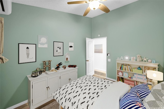 91-127 Puaina Pl, Ewa Beach, HI 96706 - bedroom featuring baseboards, a wall mounted AC, and a ceiling fan